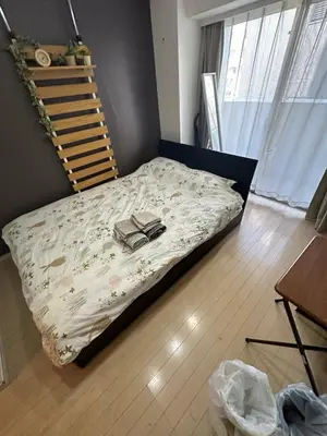 a bed with a book on it in a room at \u6e0b\u8c37\u9053\u7384\u5742307 in Tokyo