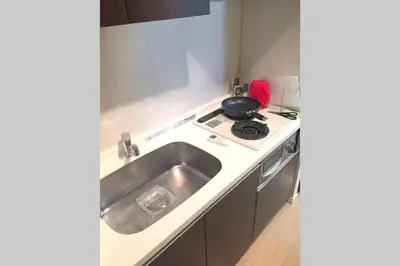 a kitchen with a sink and a stove at \u6e0b\u8c37\u9053\u7384\u5742307 in Tokyo