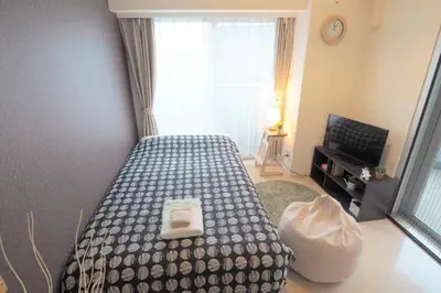 a bedroom with a bed and a window at \u6e0b\u8c37\u9053\u7384\u5742307 in Tokyo