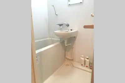 a bathroom with a sink and a bath tub at \u6e0b\u8c37\u9053\u7384\u5742401 in Tokyo