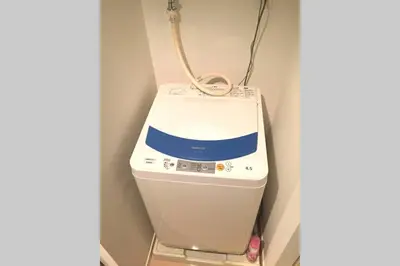 a washer and dryer in a corner of a room at \u6e0b\u8c37\u9053\u7384\u5742401 in Tokyo