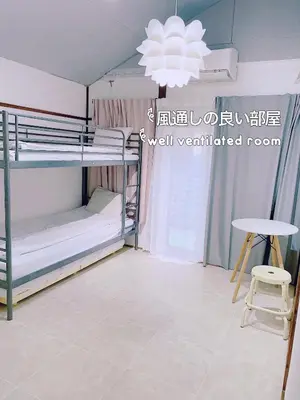 a room with bunk beds and a table and a chandelier at 2 type room, Akira&chacha guest home杉並区世田谷direct to shinjuku for 13 min 上北沢3分 近涉谷新宿Suitable for three or more people in Tokyo