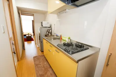 a kitchen with a sink and a stove at Tokyo Enjoy Hotel in Tokyo
