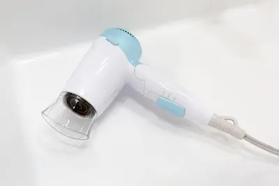 a white and blue electric toothbrush on a white background at Tokyo Enjoy Hotel in Tokyo