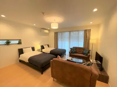 a hotel room with a bed and a couch at Salon Shibuya - Vacation STAY 78188 in Tokyo