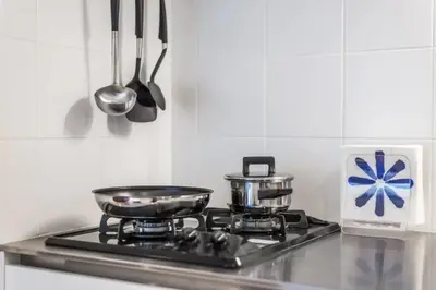 a stove top with two pots and pans on it at Salon Shibuya - Vacation STAY 78188 in Tokyo