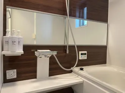 a bathroom with a bath tub and a sink at Salon Shibuya - Vacation STAY 78188 in Tokyo