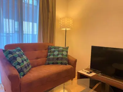 a living room with a couch and a flat screen tv at Salon Shibuya - Vacation STAY 78188 in Tokyo