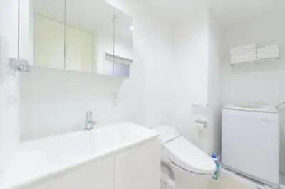 a white bathroom with a sink and a toilet at Salon Shibuya - Vacation STAY 78183 in Tokyo