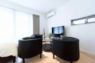a bedroom with two black chairs and a desk at Salon Shibuya - Vacation STAY 78183 in Tokyo