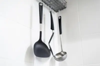 a group of kitchen utensils hanging on a wall at Salon Shibuya - Vacation STAY 78186 in Tokyo