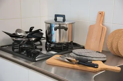 a stove top with a pot and a cutting board at Salon Shibuya - Vacation STAY 78187 in Tokyo