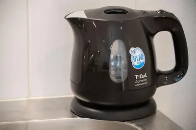 a black tea kettle sitting on top of a counter at Salon Shibuya - Vacation STAY 78187 in Tokyo