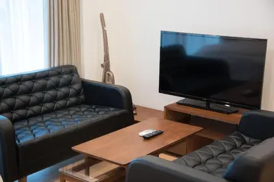 a living room with a couch and a large flat screen tv at Salon Shibuya - Vacation STAY 78187 in Tokyo