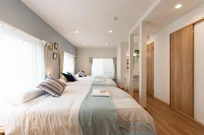 a bedroom with two large beds with pillows at TK Court Ojima - Vacation STAY 91237 in Tokyo