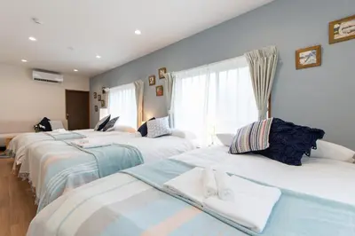 a group of four beds in a room at TK Court Ojima - Vacation STAY 91237 in Tokyo