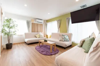 a living room with two white couches and a tv at TK Court Ojima - Vacation STAY 91237 in Tokyo