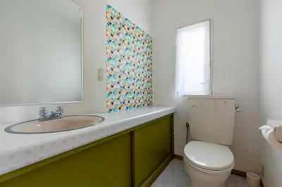 a bathroom with a sink and a toilet at ColorBee Shinjuku Yotsuya Big House in Tokyo