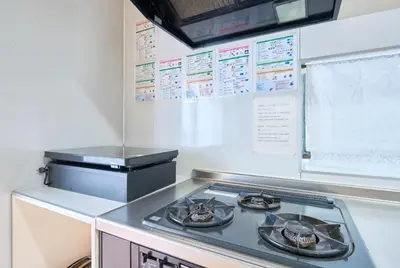 a kitchen with a stove top in a kitchen at ColorBee Shinjuku Yotsuya Big House in Tokyo
