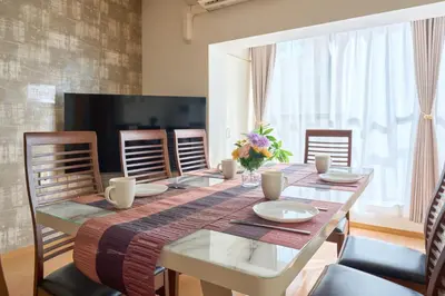 a dining room with a table and chairs at ColorBee Shinjuku Yotsuya Big House in Tokyo