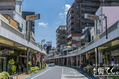 a street in a city with buildings and a road at Green House 101 in Tokyo