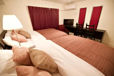 a hotel room with two beds and a desk and a desk at Prime Stage Otsuka 204 - Vacation STAY 8875 in Tokyo