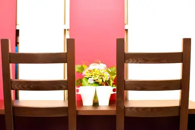 two wooden chairs sitting next to a table with flowers at Prime Stage Otsuka 204 - Vacation STAY 8875 in Tokyo