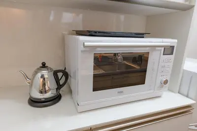 a microwave oven on a counter with a tea kettle at Katsushika-ku - House - Vacation STAY 89073 in Tokyo