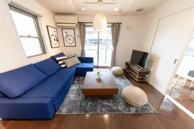 a living room with a blue couch and a table at Katsushika-ku - House - Vacation STAY 89073 in Tokyo