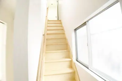 a staircase in a room with a window at Sunstay - Shinbamba 1 in Tokyo
