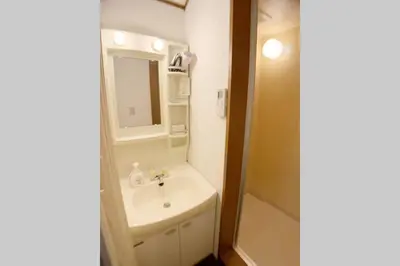 a bathroom with a sink and a mirror at Sun Stay \u5927\u5d0e1 in Tokyo