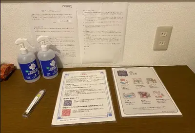 a table with a menu and two bottles of food at Sun Stay \u5927\u5d0e1 in Tokyo
