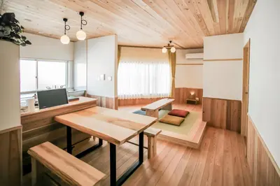 a living room with a table and a television at morino yume private lodging Wood-warm cozy stays \u675c\u30ce\u5922 \u6c11\u6cca \u6728\u306e\u9999\u308a\u6f02\u3046\u5fc3\u5730\u3088\u3044\u7a7a\u9593 in Tokyo