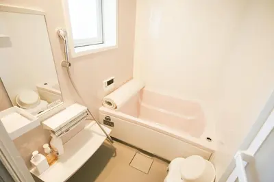 a bathroom with a sink and a toilet and a mirror at morino yume private lodging Wood-warm cozy stays \u675c\u30ce\u5922 \u6c11\u6cca \u6728\u306e\u9999\u308a\u6f02\u3046\u5fc3\u5730\u3088\u3044\u7a7a\u9593 in Tokyo