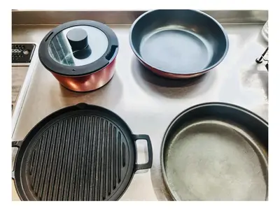 a stove top with two pans and a strainer at morino yume private lodging Wood-warm cozy stays \u675c\u30ce\u5922 \u6c11\u6cca \u6728\u306e\u9999\u308a\u6f02\u3046\u5fc3\u5730\u3088\u3044\u7a7a\u9593 in Tokyo