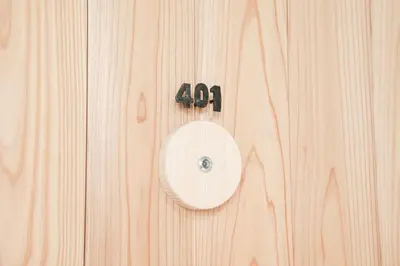 a wooden door with a number on it at morino yume private lodging Wood-warm cozy stays \u675c\u30ce\u5922 \u6c11\u6cca \u6728\u306e\u9999\u308a\u6f02\u3046\u5fc3\u5730\u3088\u3044\u7a7a\u9593 in Tokyo