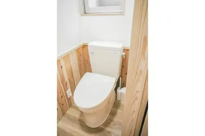 a bathroom with a white toilet in a room at morino yume private lodging Wood-warm cozy stays \u675c\u30ce\u5922 \u6c11\u6cca \u6728\u306e\u9999\u308a\u6f02\u3046\u5fc3\u5730\u3088\u3044\u7a7a\u9593 in Tokyo