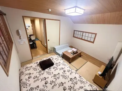 a small room with a bed and a table at Hotel EL Shinjuku 6 in Tokyo