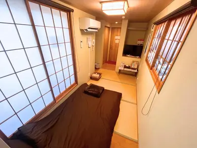 a room with a large window and a bed in it at Hotel EL Shinjuku 6 in Tokyo