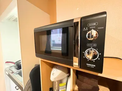 a microwave oven sitting on top of a shelf at Hotel EL Shinjuku 6 in Tokyo