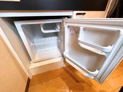 an empty refrigerator with its door open in a kitchen at Hotel EL Shinjuku 6 in Tokyo