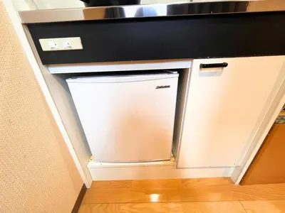 a small refrigerator in a kitchen under a counter at Hotel EL Shinjuku 6 in Tokyo