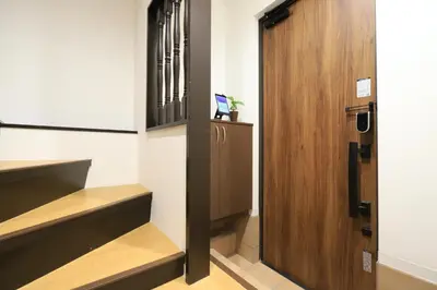 a hallway with a wooden door and stairs at Katsushika-ku - House - Vacation STAY 92154 in Tokyo