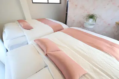 a bedroom with two beds and a potted plant at Katsushika-ku - House - Vacation STAY 92154 in Tokyo
