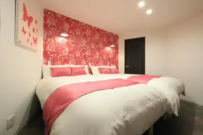 a bedroom with a large bed with a red wall at Katsushika-ku - House - Vacation STAY 92154 in Tokyo
