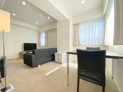 a living room with a couch and a table at Pangoo Shinagawa in Tokyo