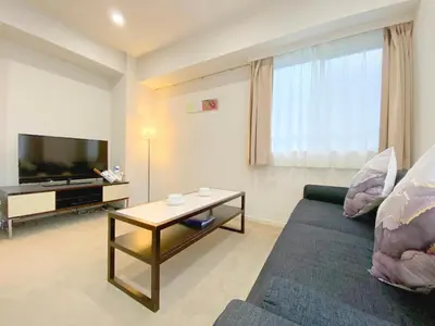 a living room with a couch and a table at Pangoo Shinagawa in Tokyo