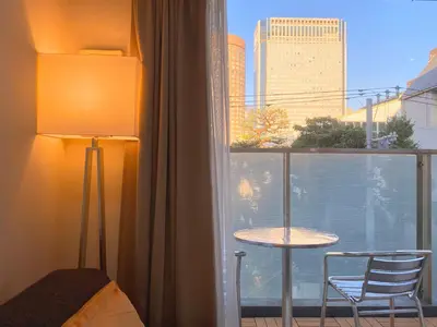 a room with a window with a table and a chair at Pangoo Shinagawa in Tokyo