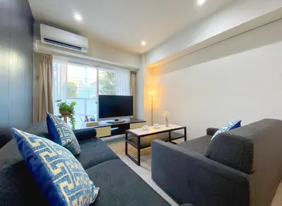 a living room with a couch and a television at Pangoo Shinagawa in Tokyo