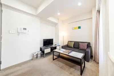 a living room with a couch and a table at Pangoo Shinagawa in Tokyo